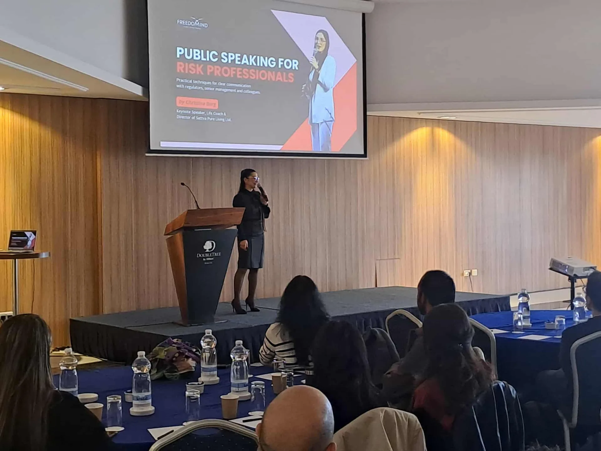 Christine speaking on stage